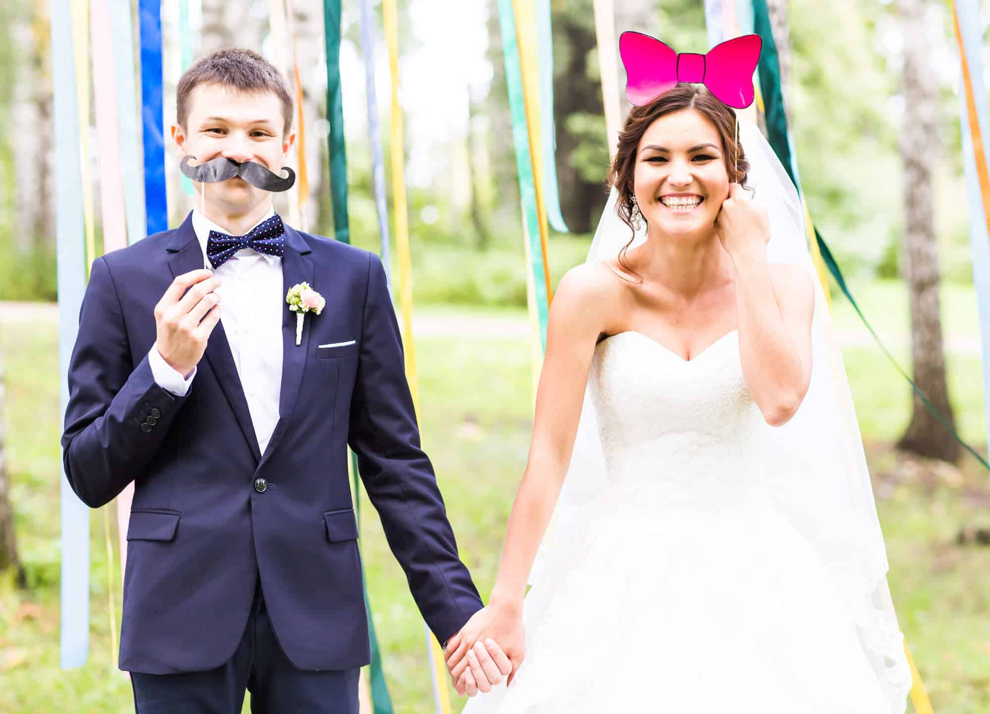 Happy Couple Posing in Front of a Photo Booth